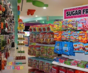 colored candy shop featuring aisles of packaged gummy candies