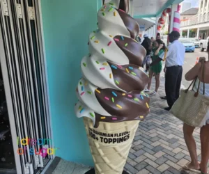decorative statue of a chocolate and vanilla soft-serve ice cream cone with colorful sprinkles