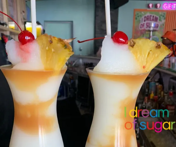 Two frozen milkshake in hurricane glasses
